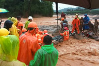 | Photo: PTI : NDRF personnel conduct rescue operation after landslide